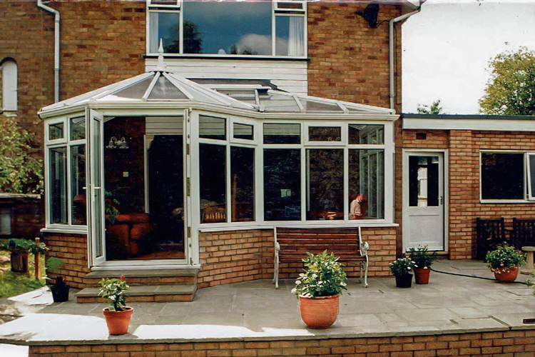 White P shape combination conservatory with 35mm Heat guard polycarbonate roof sheets & French doors