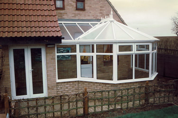 White PVCu Victorian P Shape Combination Dwarf wall Conservatory with 25mm Opal polycarbonate roof sheets & French doors