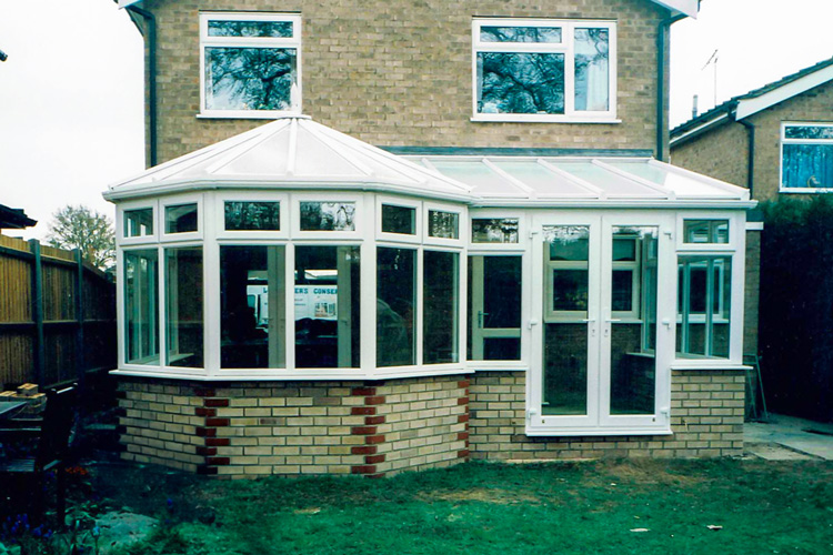 White PVCu P Shape Combination Conservatory with 35mm Heat guard polycarbonate roof sheets & French doors