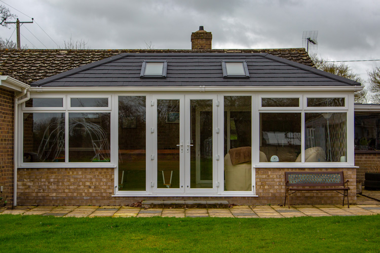 "Double Hip Edwardian with Metrotile Charcoal tiles Velux opening windows