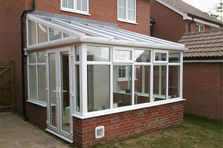 White PVCu Lean-To Conervatory with solar control glass roof sheets, French doors & 600mm dwarf wall