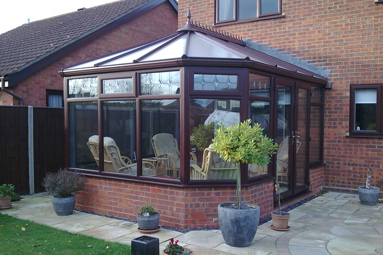 Rose wood effect PVCu Victorian Conservatory with unequal bays